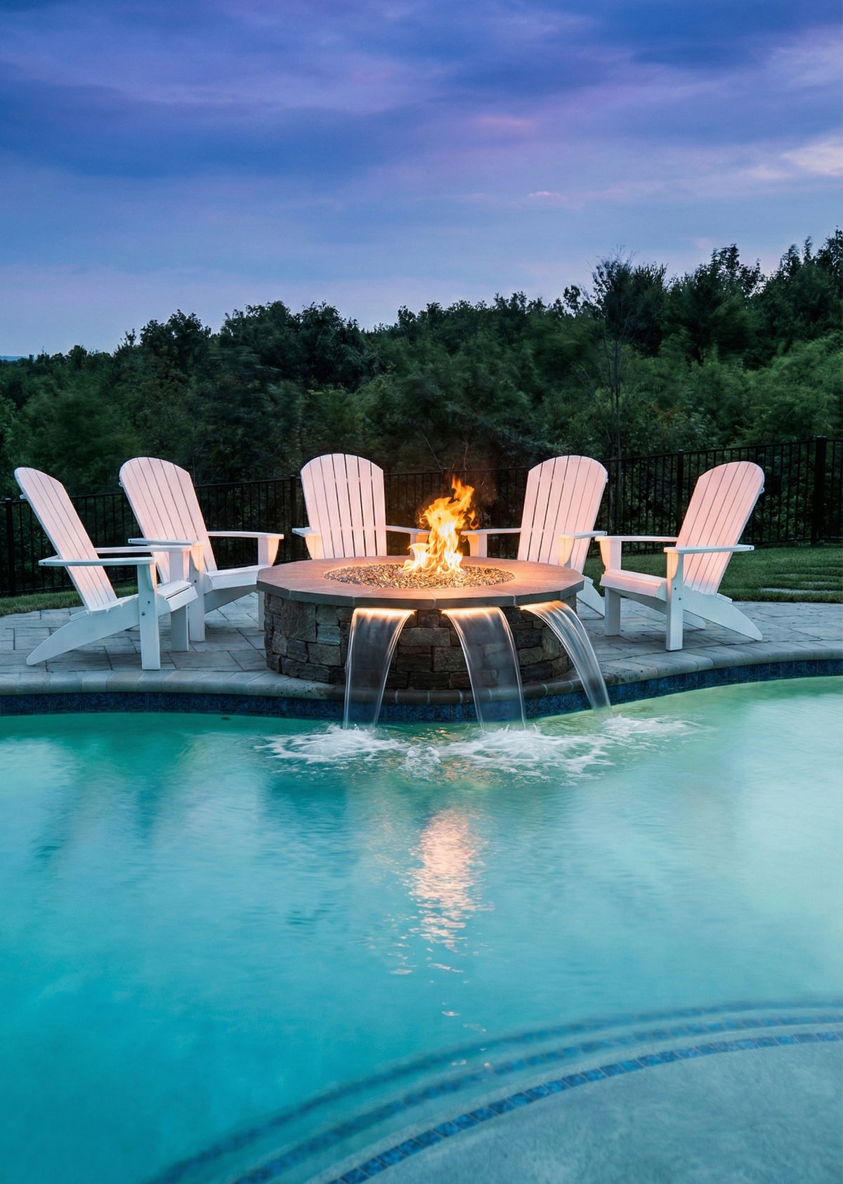 Round paver fire pit with a Warming Trends gas insert kit near a pool